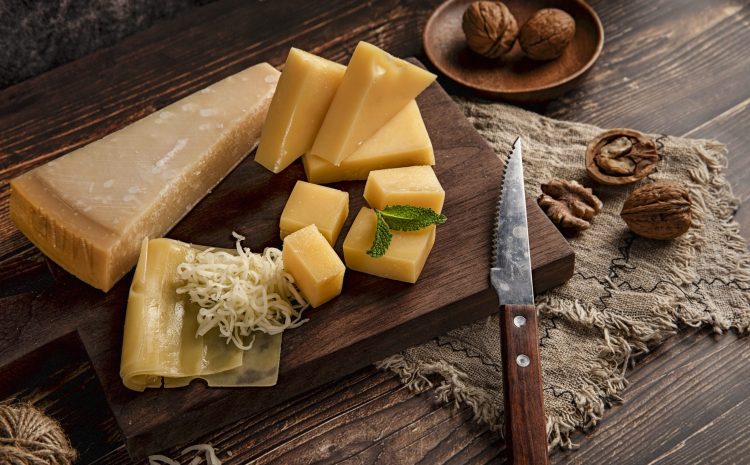 A selective focus shot of a delicious cheese platter on the table with walnuts on it