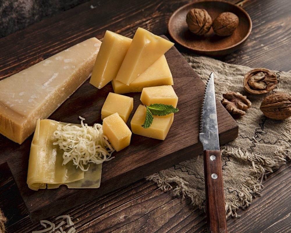A selective focus shot of a delicious cheese platter on the table with walnuts on it